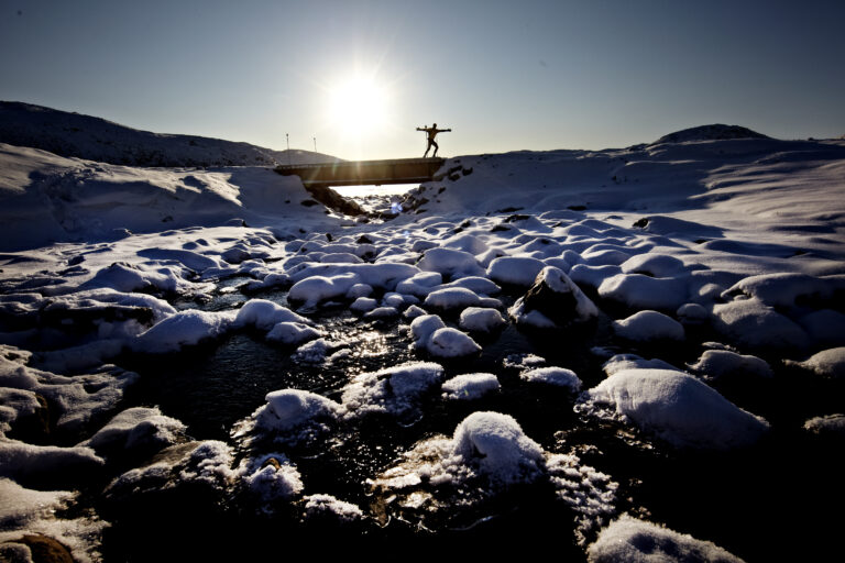A lone runner passes in the distance during the Polar Circle Marathon 2024