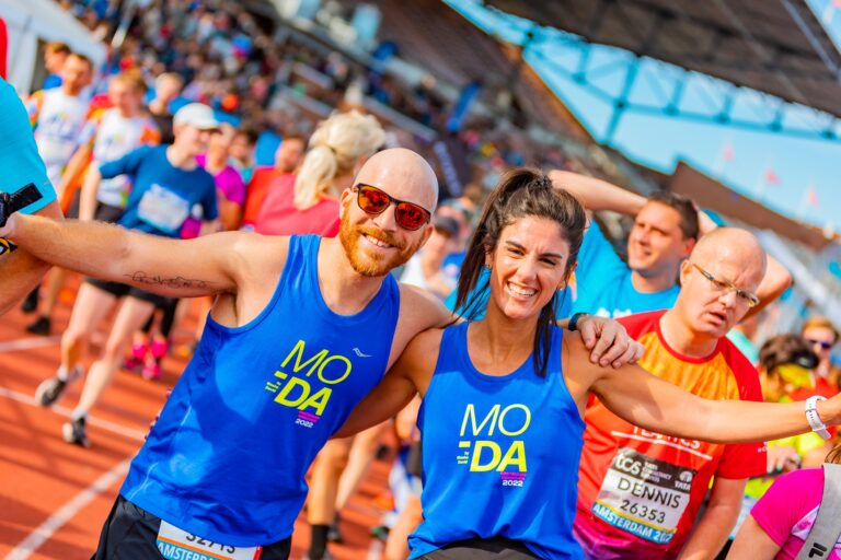Photo of runners celebrating after finishing the Amsterdam Marathon 2024