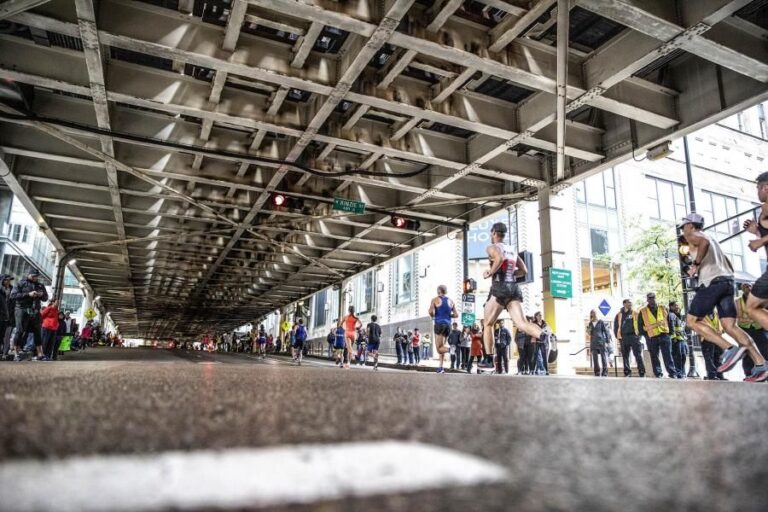 Photo of runners passing under the Chicago metro lines during the Chicago Marathon 2024