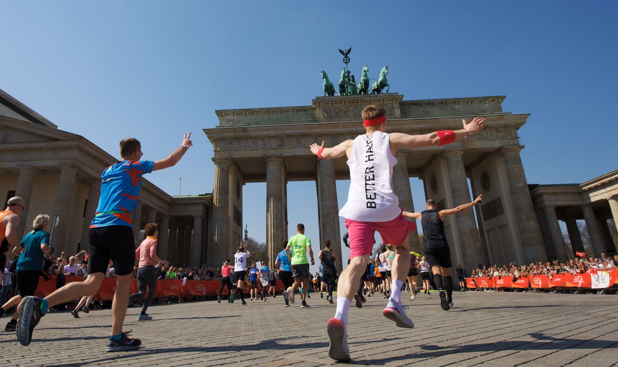 Runners cross the finish line of the Berlin Half Marathon 2025 at the Brandenburg Gate in Berlin.