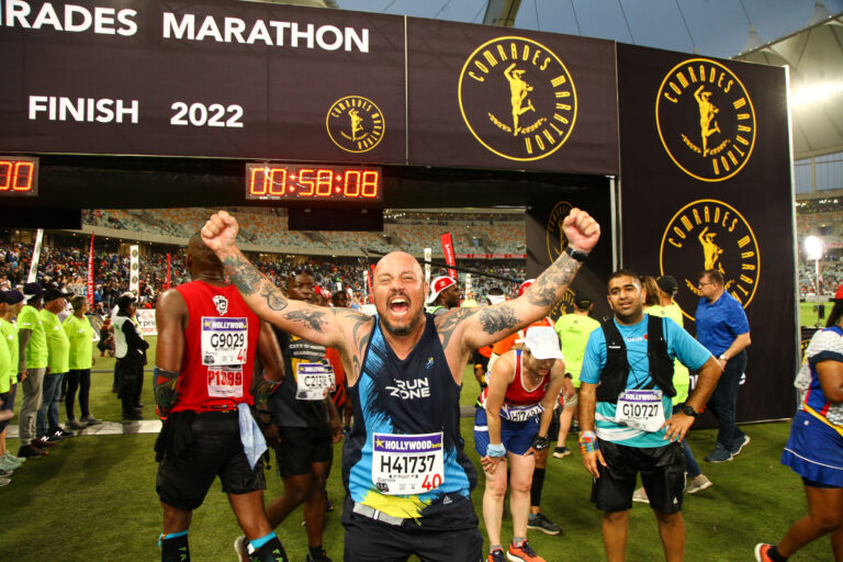 Photo of runners celebrating having completed the Comrades Marathon 2025