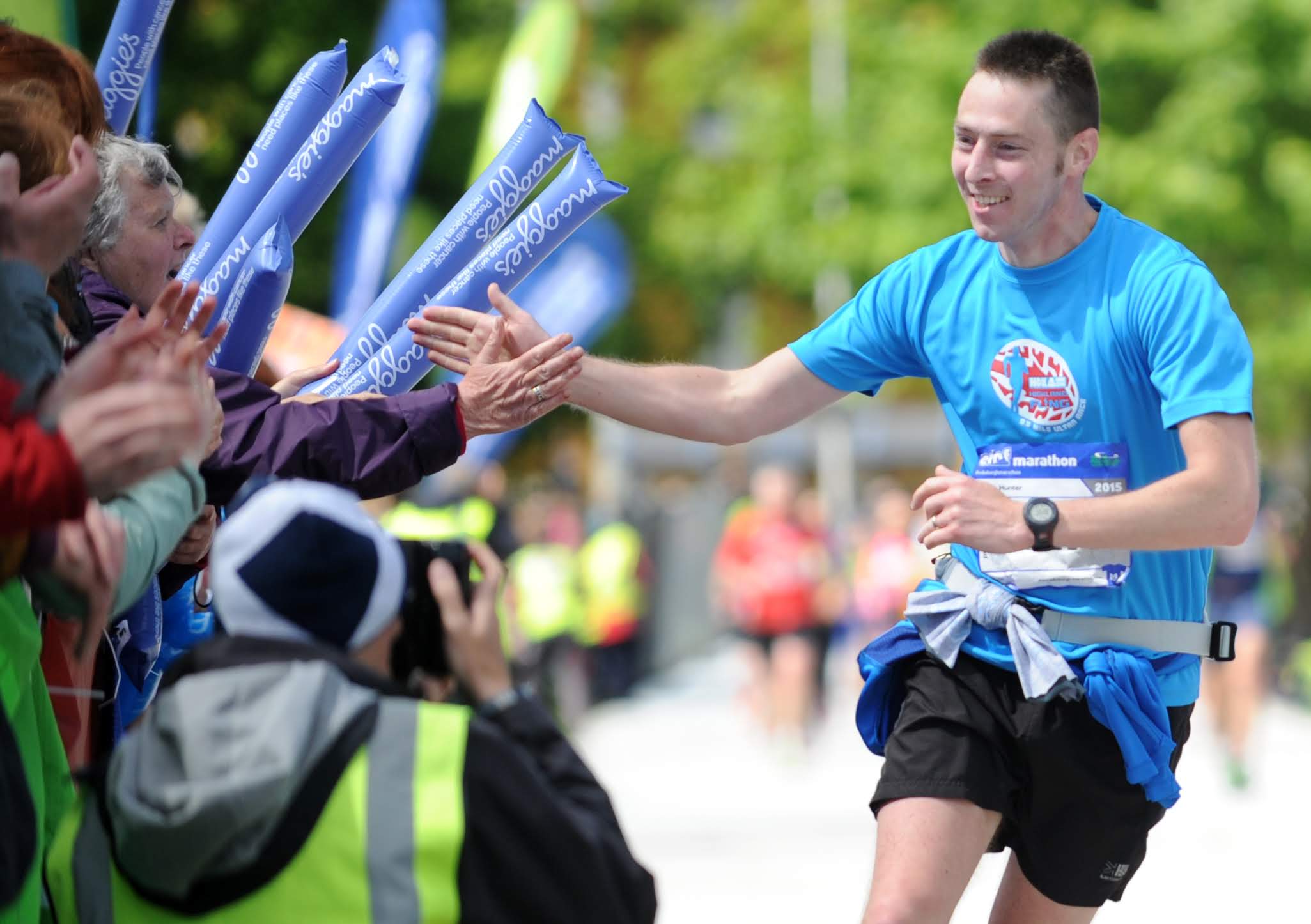 Photo of a runner interacting with crowds at the Edinburgh Marathon 2025