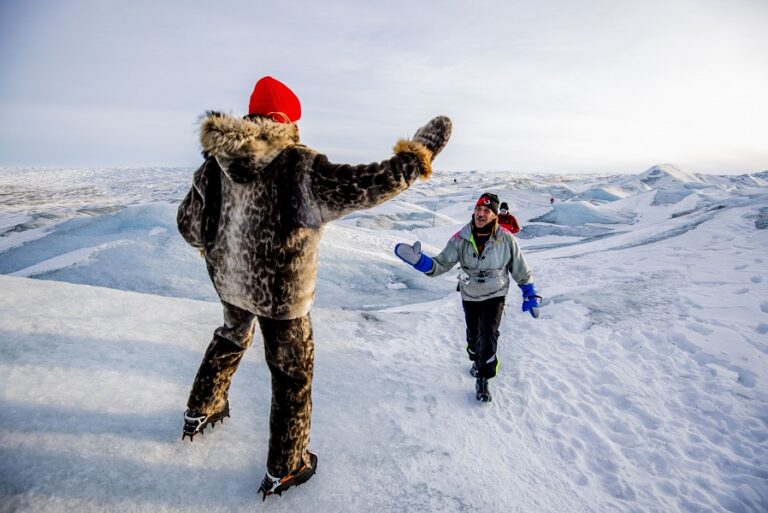 Runners high fiving during the Polar Circle Marathon 2024