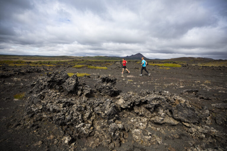 Runners crossing over beautiful terrain on the Iceland Volcano Marathon 2025