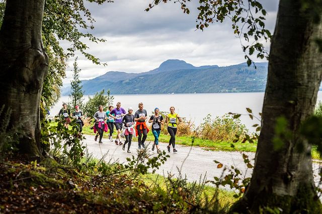 Runners in the foreground as they pass by Loch Ness during the Loch Ness Marathon 2025
