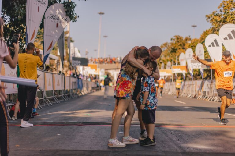 A runner embraces his family following completion of the Rio De Janeiro Marathon