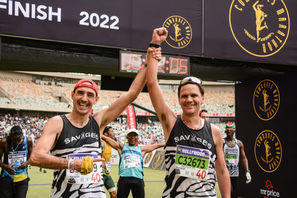 Runners celebrate having finished the Comrades Marathon, one of the marathons Seven Continents Club members can get early access to