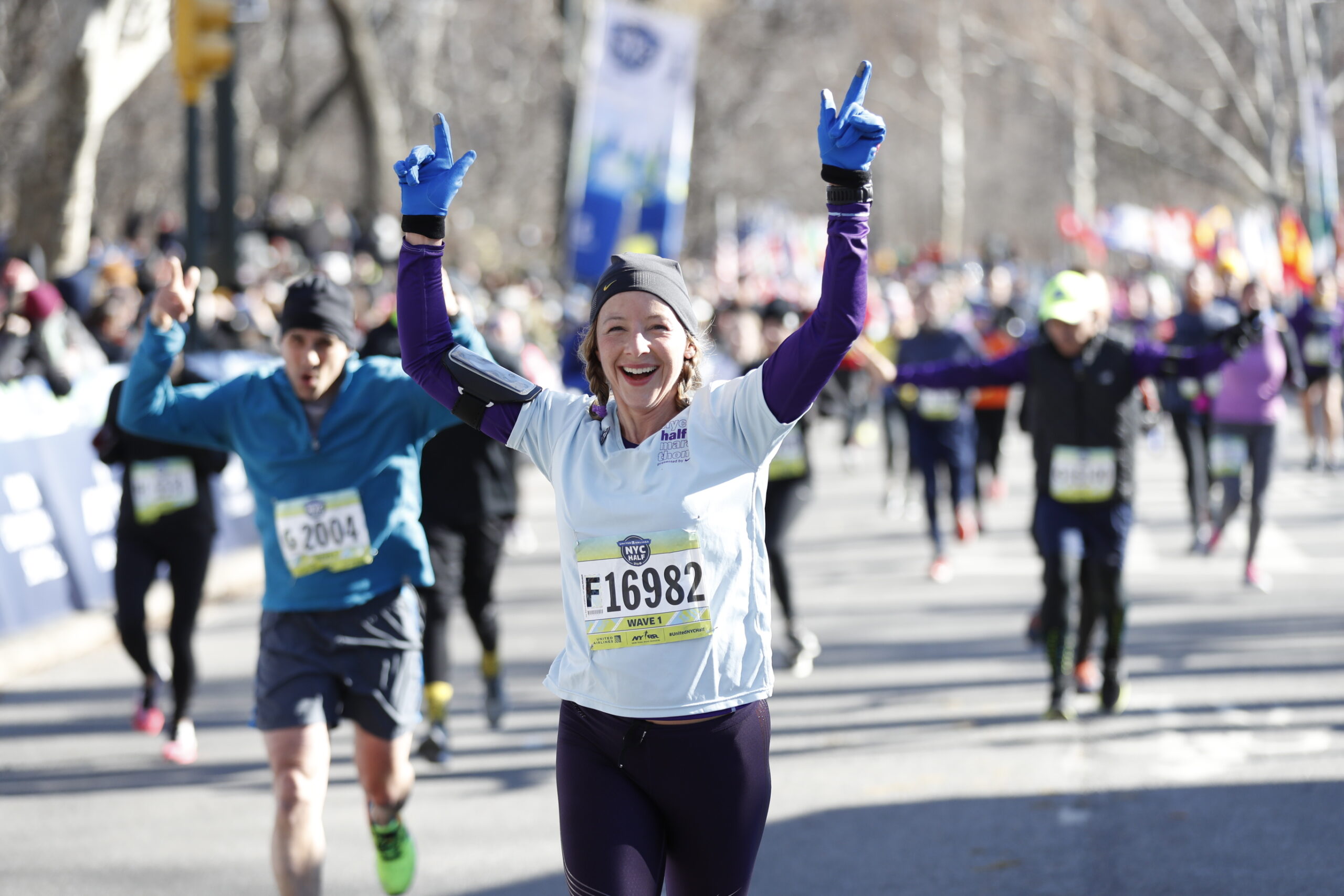 Photo of a runner crossing the finish line at the New York Half Marathon 2025