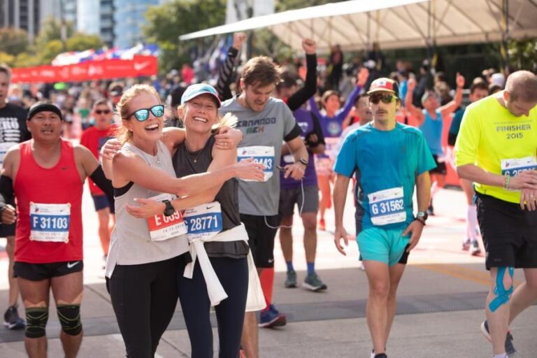 Picture of runners embracing following the end of the Chicago Marathon 2024